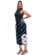 Load image into Gallery viewer, Woman wearing a black sleeveless top and a black and blue patterned skirt with white feather details on a white background