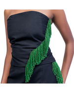 Load image into Gallery viewer, Black strapless dress with green beaded detailing on a plain background
