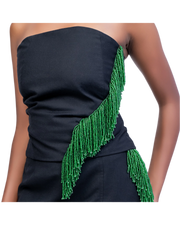 Black strapless dress with green beaded detailing on a plain background