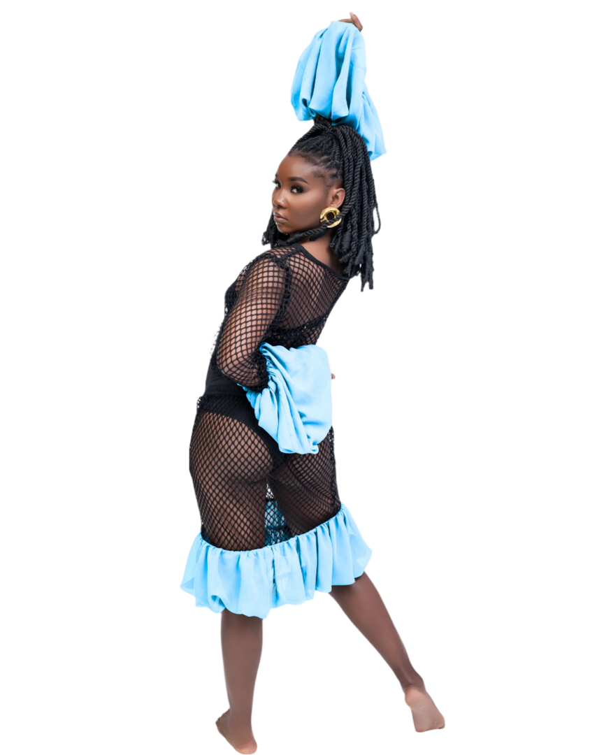 Person wearing a black fishnet top and light blue skirt on a white background