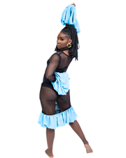 Person wearing a black fishnet top and light blue skirt on a white background