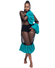 Woman wearing a black fishnet top and teal skirt with green jacket on a white background