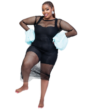 Woman wearing a black fishnet outfit with sheer sleeves and gloves on a white background