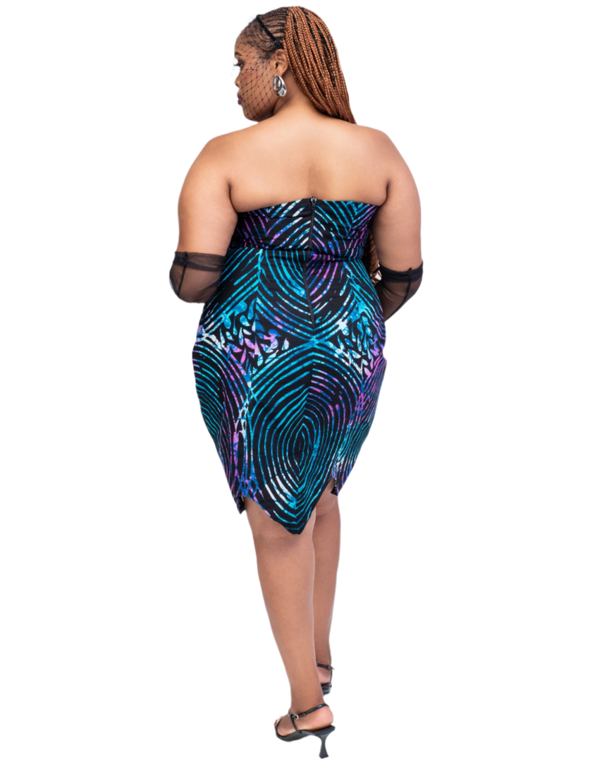 Woman wearing a strapless dress with a colorful pattern on a white background