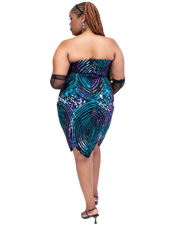 Woman wearing a strapless dress with a colorful pattern on a white background