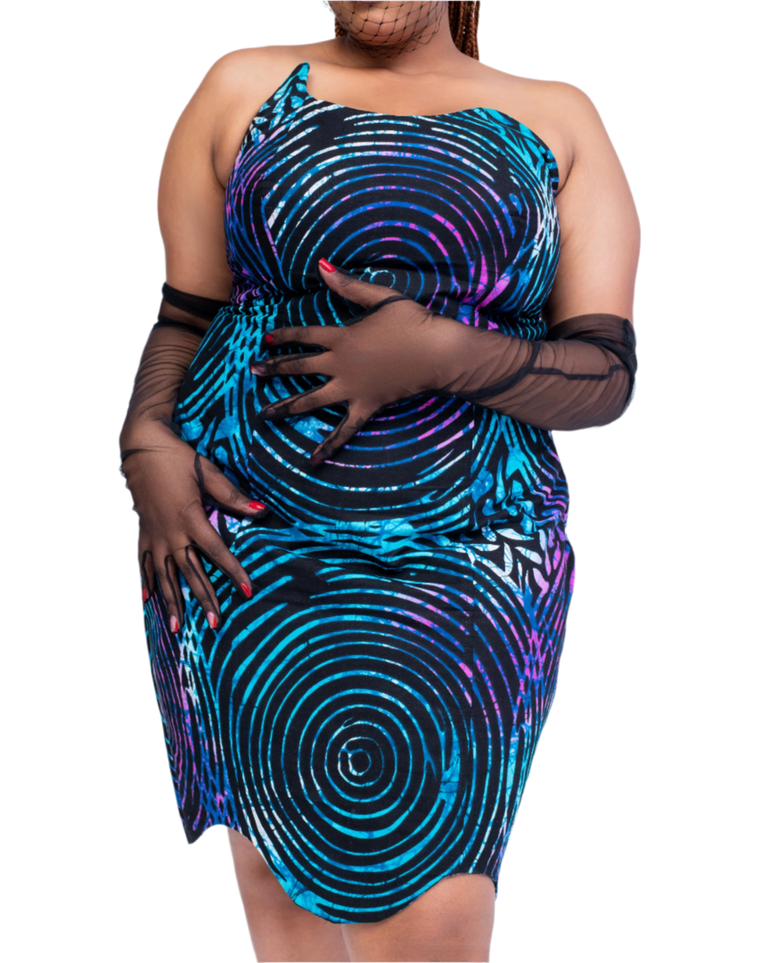 Woman wearing a blue and purple patterned dress with sheer black gloves on a white background